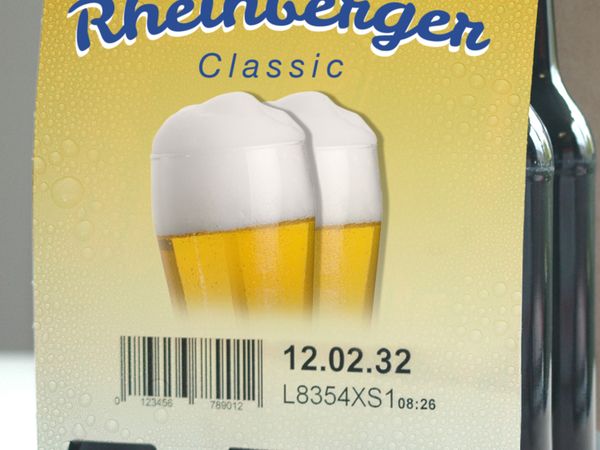 Codage industriel jet d’encre avec MHD et code-barres sur emballage carton jaune